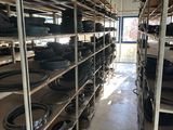 many shelves of tires in a warehouse with wheels on them