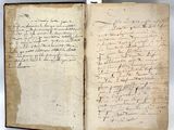an old book with writing on it sitting on top of a table