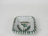 an image of a green and white plate with a bird on it