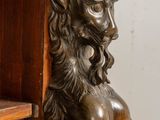 a statue of a man with a hat on his head on a shelf