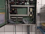 a metal cabinet with a bunch of wires in it