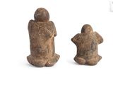 pair of ancient stone figurines of a man and a woman