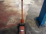 a shovel that is sitting on the ground next to a pole