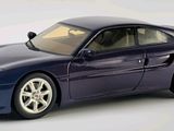 a blue toy car that is sitting on a white surface