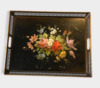 a black tray with a painting of flowers on it