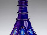purple glass vase with blue and gold designs on it