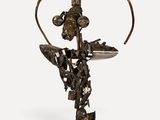 an image of a sculpture of a cross with a bird on it