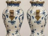 pair of blue and white vases with gold accents on a table
