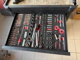 a tool box full of tools on a tile floor