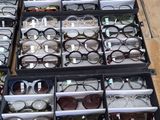 many glasses on display in the window of a store