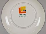 a white plate with a yellow and orange logo on it