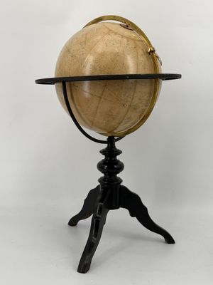 an antique globe on a tripod with a wooden stand