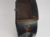 a small black box with a dandelion in it