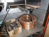 a shelf with a bunch of copper wire on it