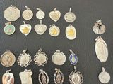 a lot of silver and silver jewelry on a black surface