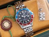 a watch in a box with a wax seal and a wax seal