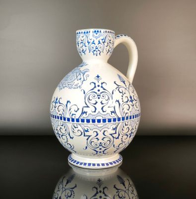 a blue and white vase sitting on a black table