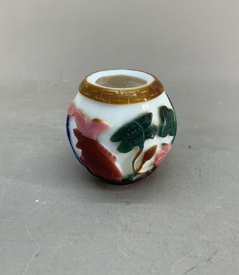 a small vase with a flower design on it on a table