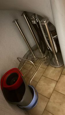 a toilet in the bathroom with a red lid