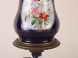 a blue lamp with a floral design on it