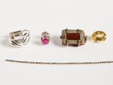 three pieces of jewelry including a ring, a necklace, and a chain