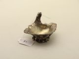 a small silver bowl on a table with a price tag on it