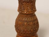 a small brown vase that is sitting on a table