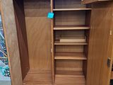 an image of a wooden cabinet with a door open