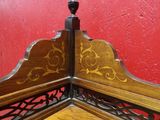 a corner of a bed with a red wall in the background