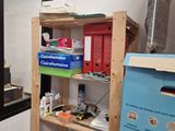 a shelf that has many items on it in the room