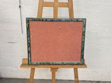 a easel that has a painting on it on a stand