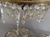 a gold plate with a glass bowl on top of it