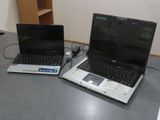 two laptops that are sitting on a table