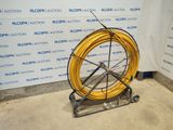 a yellow hose sitting on a stand in front of a wall