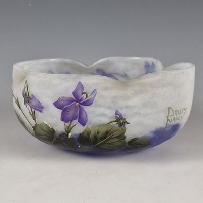 a white bowl with purple flowers painted on it