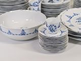 a lot of plates and bowls sitting on a table