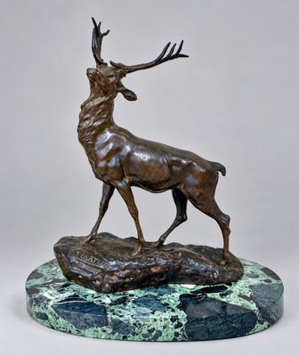 a bronze statue of a stag on a marble base