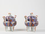 pair of blue and orange vases with handles on legs