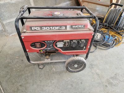 a small portable generator that is sitting on the ground
