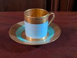 a cup and saucer sitting on a wooden table