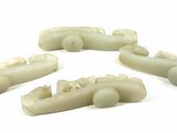 four pieces of carved soap sitting on top of a white surface