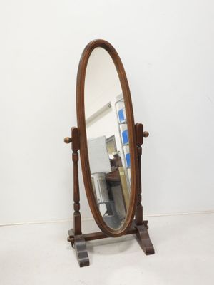 a mirror that is sitting on a stand in a room