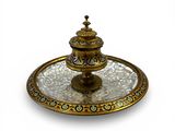an image of a gold plate with a decorative design on it