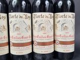 four bottles of wine are lined up on a table