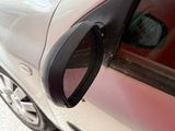 a close up of a car door handle with a hole in it