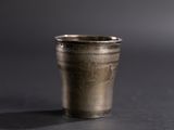 a silver cup that is sitting on a table