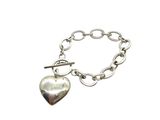 a close up of a silver bracelet with a heart on it