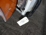 a car that has been left on the ground with a price tag attached to it
