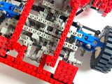 a toy car made out of legos on a white surface