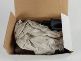 a cardboard box with a pair of scissors inside of it
